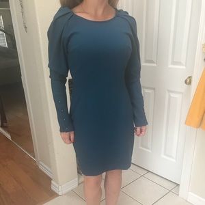 Gorgeous color dress with 80’s shoulders.